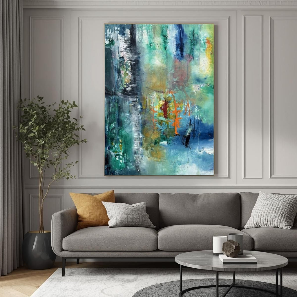 Abstract original oil painting, blue and teal abstract textures with orange accents on a wall above a gray sofa with decorative pillows in a living room setting.